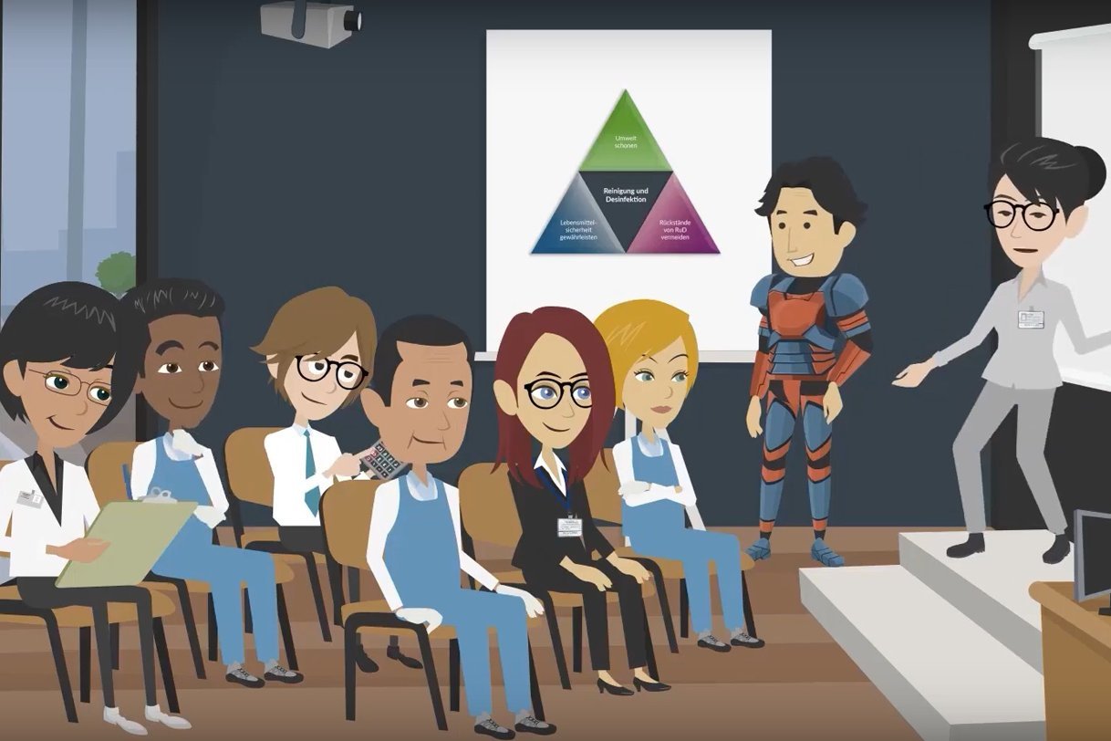 Ausschnitt aus einem animierten Kurzfilm: Eine Rednerin spricht vor Menschen, die in einem Schulungsraum sitzen. Klick führt zu Großansicht in einer Lightbox. Zum Schließen der Lightbox ESC drücken.